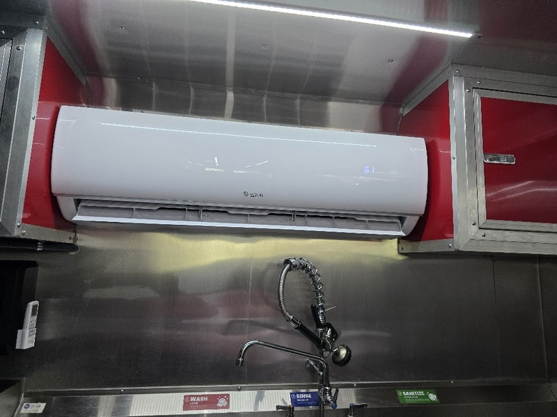 Mini-split air conditioning unit installed inside BBQ food trailer